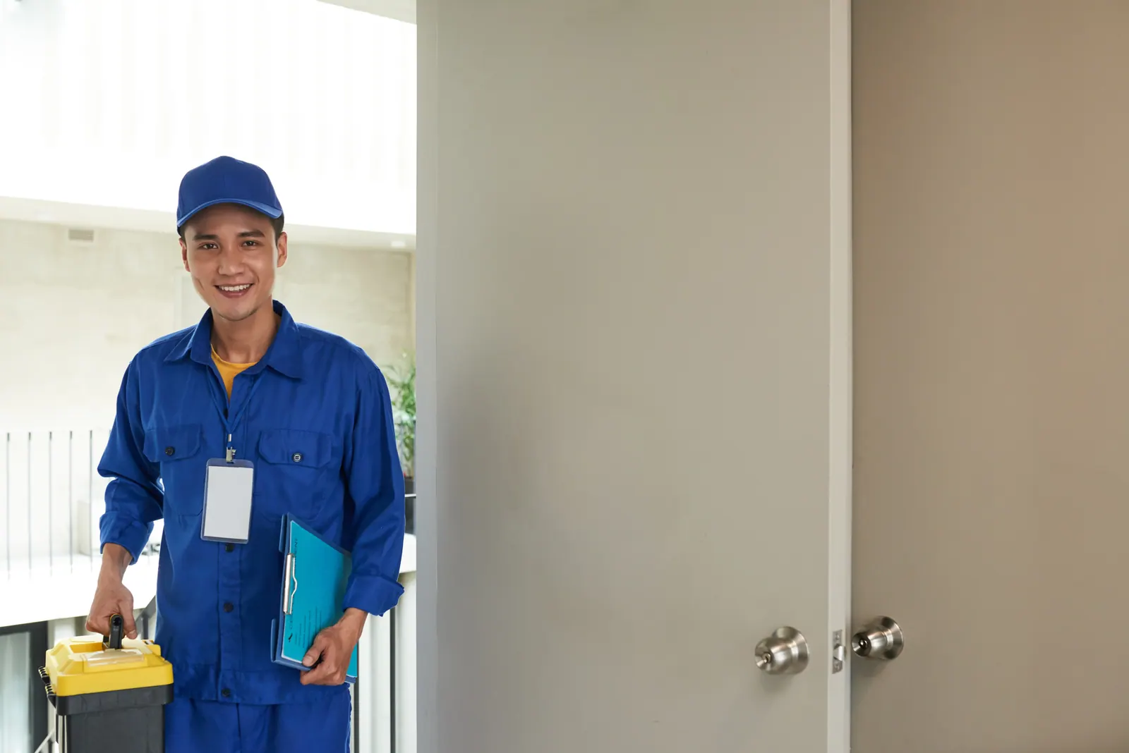 An Ayos Lamig technician arriving at a customer's door with his toolbox and job sheet